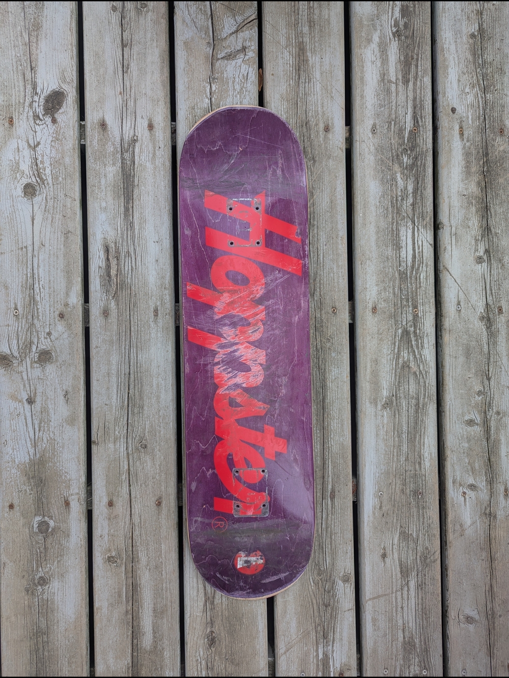 Purple Skate Deck with Red Graphic Logo